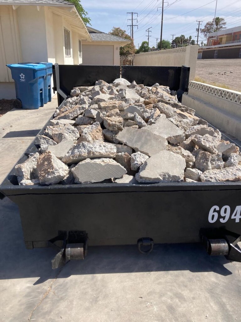 6 yard lowboy dumpster filled with broken concrete - Las Vegas.