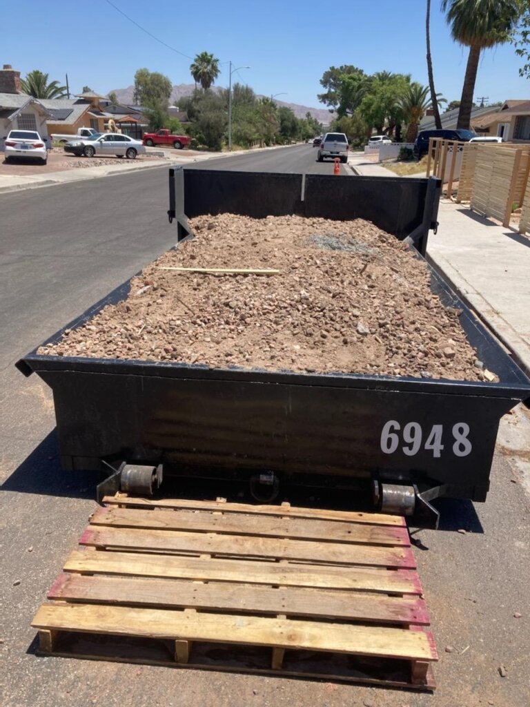 6 yard lowboy dumpster filled with dirt - Las Vegas.