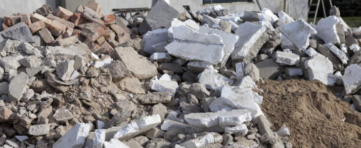Construction waste from the revitalization of an old house. Pieces of polystyrene and construction rubble are in front of the house for removal
