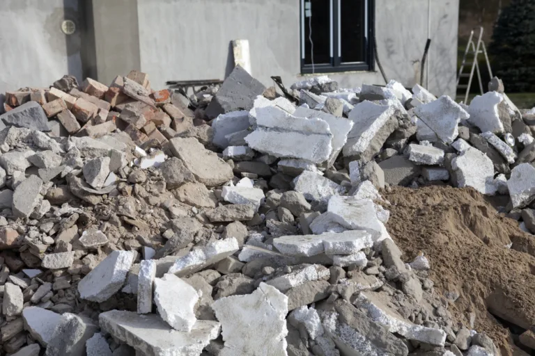 Construction waste from the revitalization of an old house. Pieces of polystyrene and construction rubble are in front of the house for removal