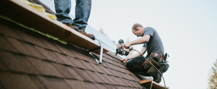 A roofer and crew work on putting in new roofing shingles. Small local business serving local families in Washington State.