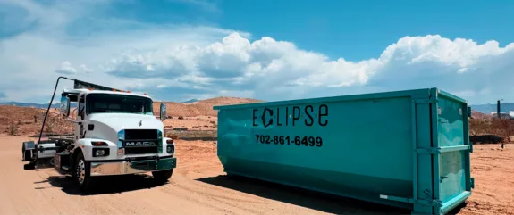 Work truck next to a dumpster labeled Eclipse