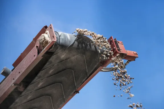 closeup conveyor belt carrying gravel