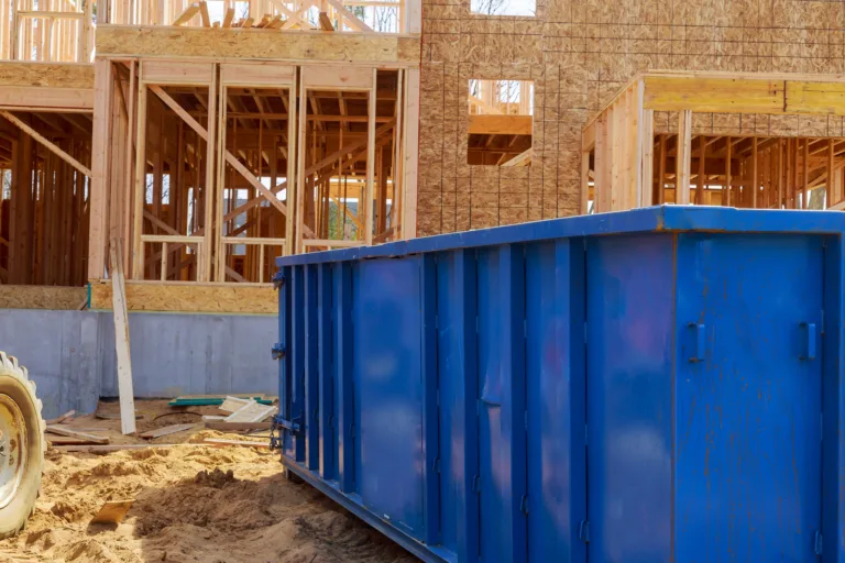 Dumpster in front of under construction house